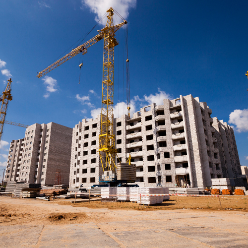 Construction site with cranes and modern buildings under development
